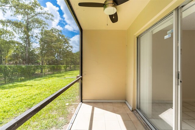 unfurnished sunroom featuring ceiling fan