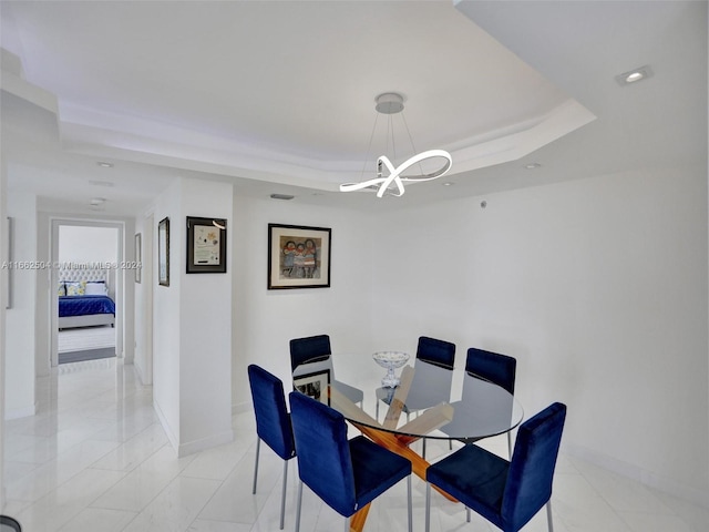 dining space with a tray ceiling