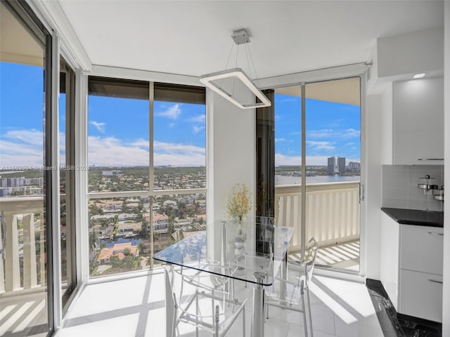 unfurnished dining area featuring a wall of windows, tile patterned floors, and a wealth of natural light