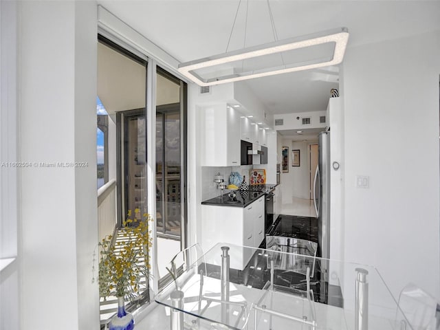 kitchen with white cabinets, appliances with stainless steel finishes, and decorative backsplash