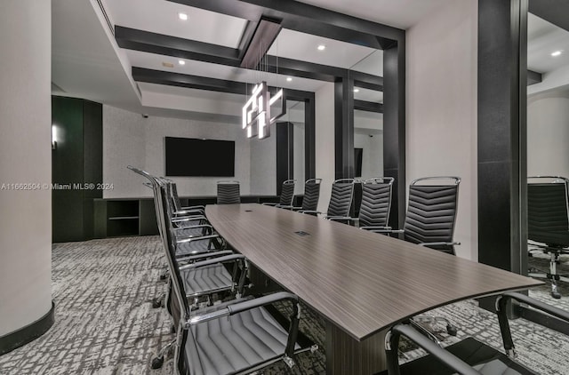 carpeted office space featuring beam ceiling