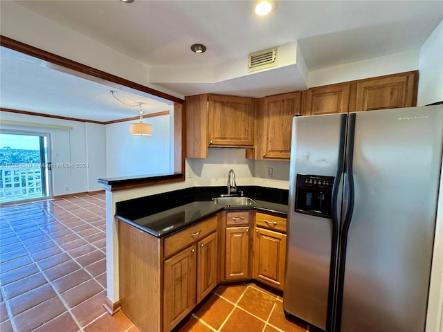 kitchen with stainless steel fridge with ice dispenser, light tile patterned floors, pendant lighting, and sink