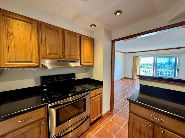 kitchen featuring light tile patterned floors, ornamental molding, and stainless steel range with electric cooktop