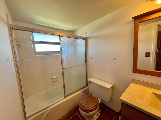 full bathroom featuring tile patterned floors, vanity, toilet, and shower / bath combination with glass door