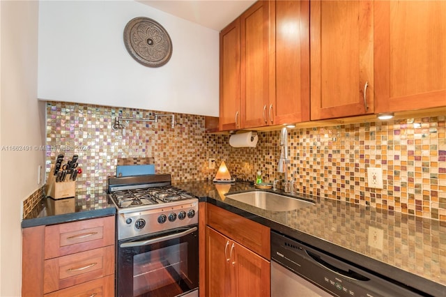 kitchen with stainless steel appliances, dark stone counters, sink, and backsplash