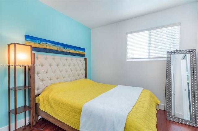 bedroom with dark hardwood / wood-style floors