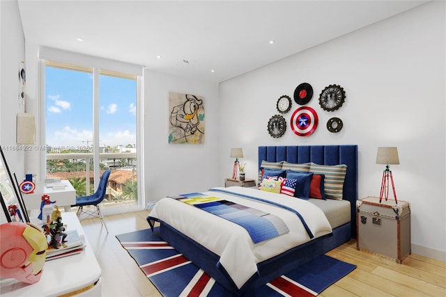 bedroom featuring wood finished floors and recessed lighting