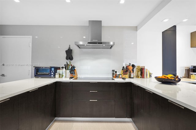 kitchen featuring black electric stovetop, light stone countertops, extractor fan, and tasteful backsplash