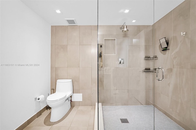 bathroom with tile walls, a shower with shower door, toilet, and tile patterned floors