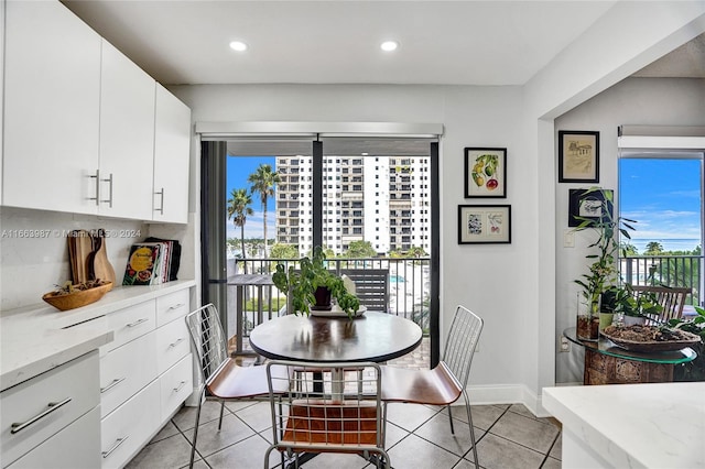 tiled dining space featuring plenty of natural light