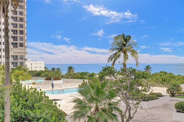 view of swimming pool featuring a water view