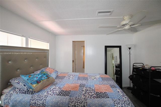 bedroom with dark hardwood / wood-style floors and ceiling fan