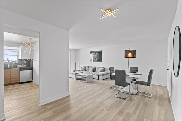 dining space featuring light hardwood / wood-style floors and a chandelier