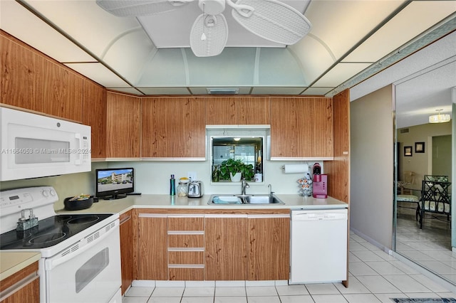 kitchen with white appliances, ceiling fan, light tile patterned floors, and sink