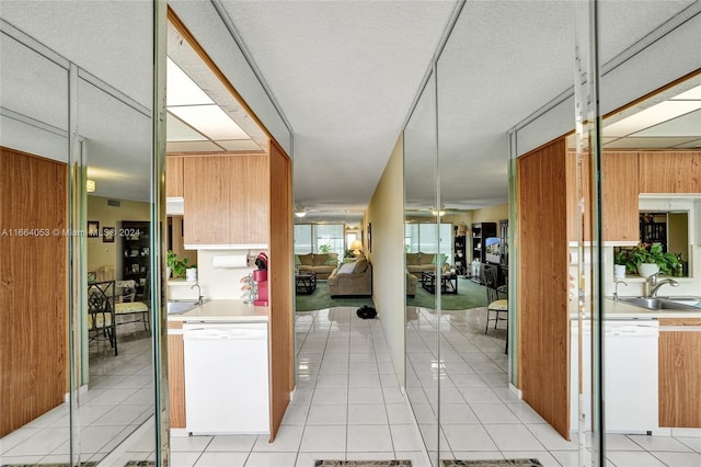 kitchen featuring white appliances, light tile patterned floors, sink, and ceiling fan