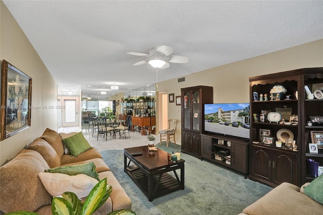 carpeted living room featuring a textured ceiling and ceiling fan