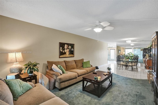 tiled living room featuring a textured ceiling and ceiling fan