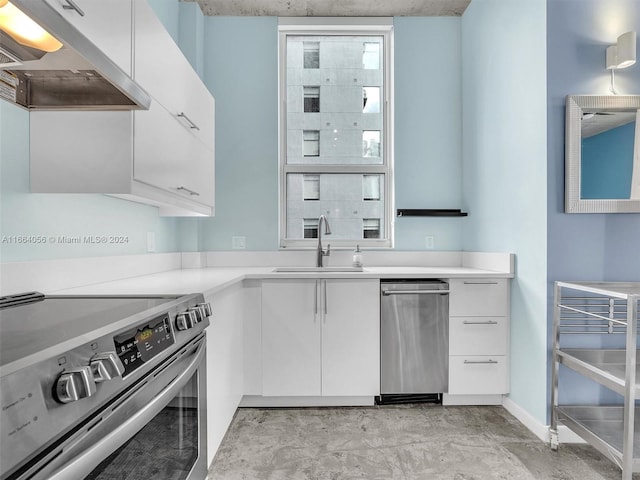 kitchen with stainless steel electric stove, sink, extractor fan, and white cabinetry