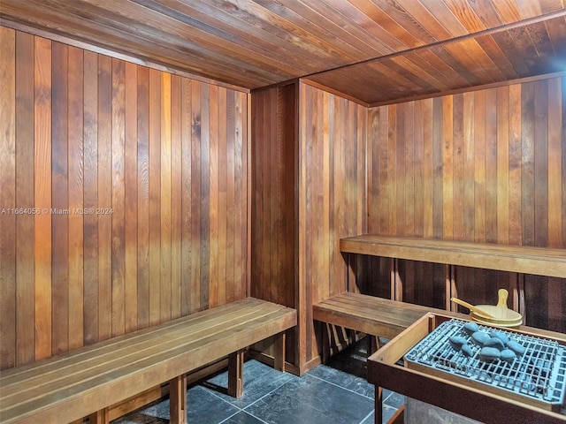 view of sauna featuring wooden walls, wooden ceiling, and tile patterned floors