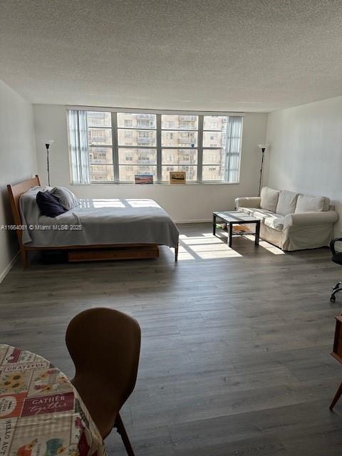 bedroom featuring hardwood / wood-style floors and a textured ceiling