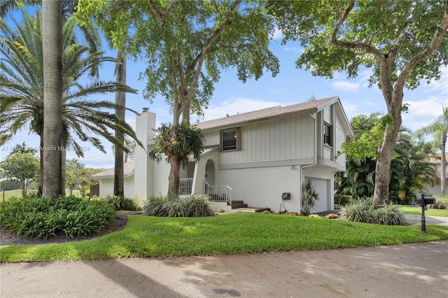 view of front of house with a front yard and a garage