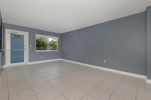 spare room featuring light tile patterned floors