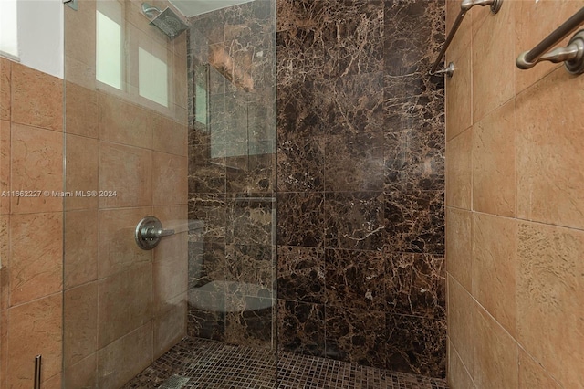 bathroom with a tile shower