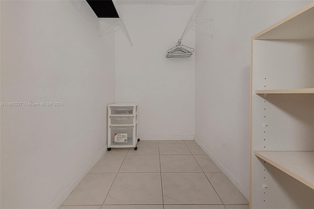 spacious closet with light tile patterned floors