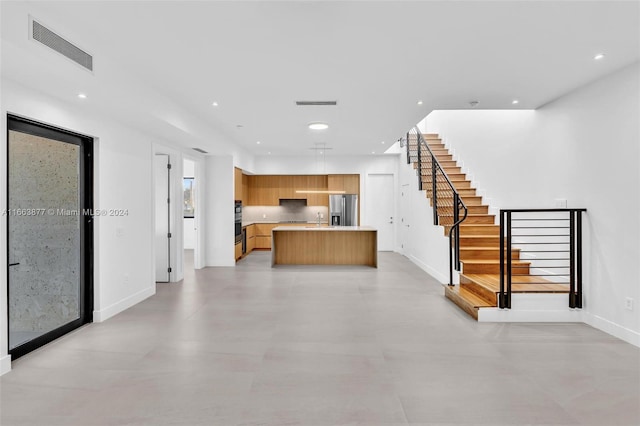 unfurnished living room with sink