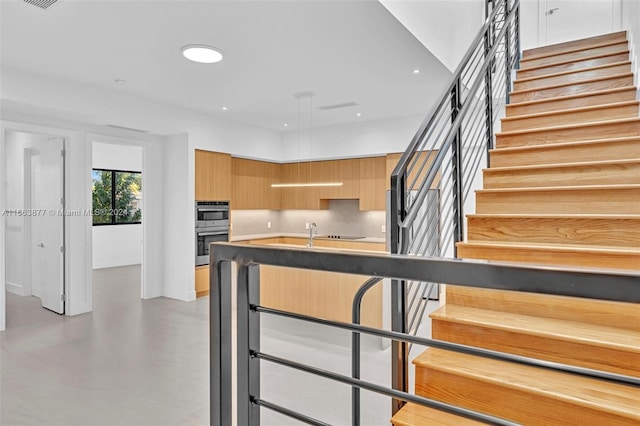 kitchen featuring backsplash and double oven