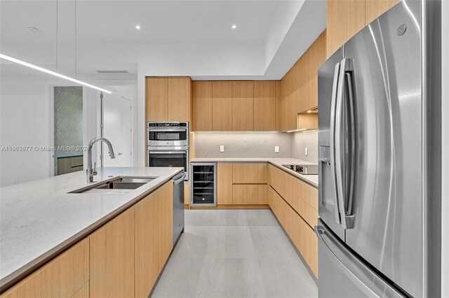 kitchen with wine cooler, sink, stainless steel appliances, backsplash, and light brown cabinetry