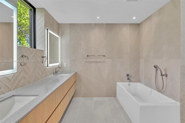 bathroom featuring tile walls, vanity, and a bathing tub