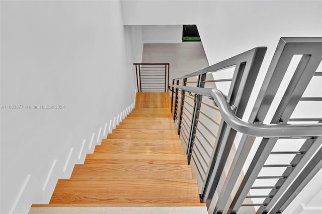 stairs featuring hardwood / wood-style flooring