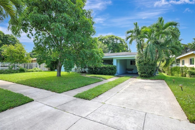 view of front of property with a front yard and a carport