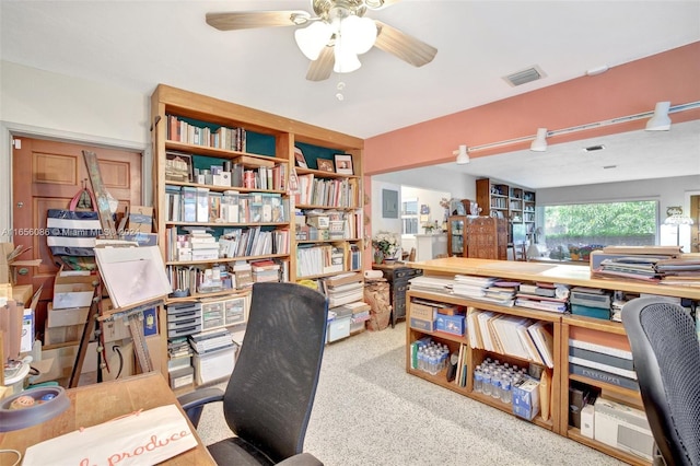 carpeted office space featuring ceiling fan