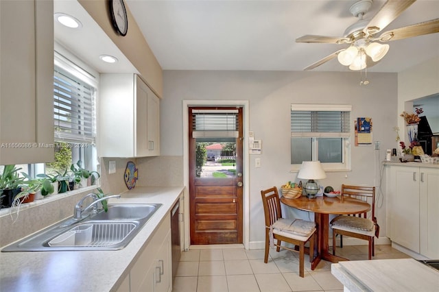 kitchen with sink, ceiling fan, and white cabinets