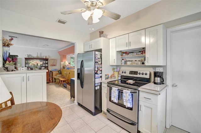 kitchen featuring ceiling fan, stainless steel appliances, and white cabinetry