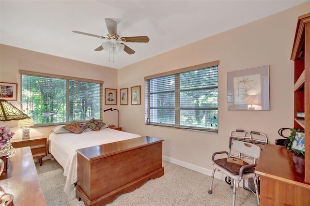 bedroom featuring multiple windows and ceiling fan