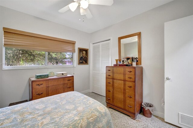 bedroom with ceiling fan, a closet, and light carpet