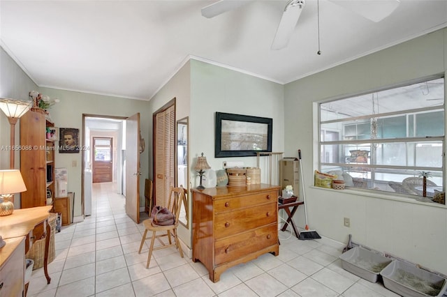 interior space featuring crown molding, light tile patterned flooring, and ceiling fan