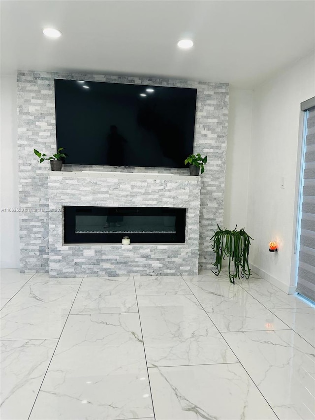 unfurnished living room with a stone fireplace