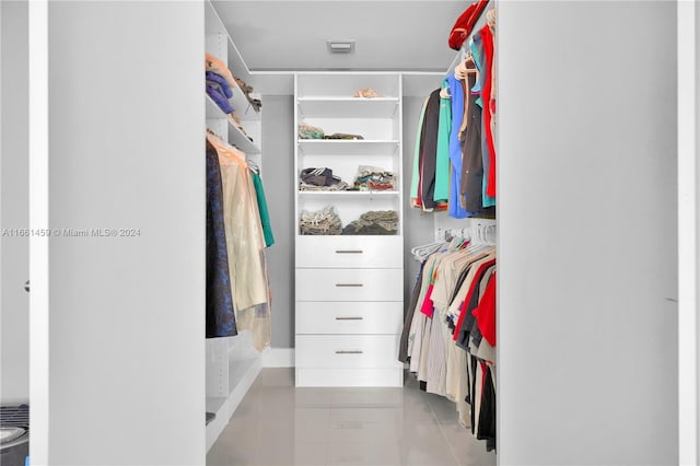 spacious closet featuring light tile patterned floors