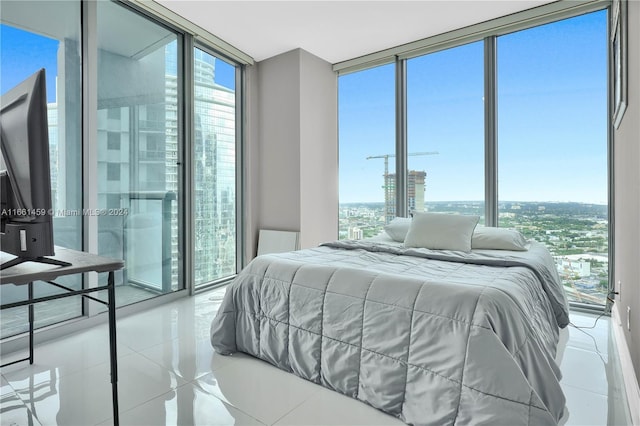 tiled bedroom featuring expansive windows and multiple windows