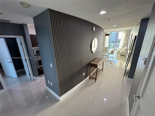 corridor featuring light tile patterned floors