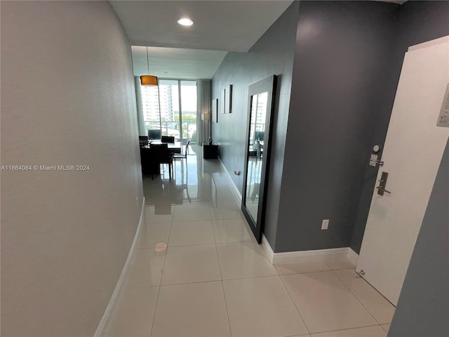 hall featuring light tile patterned floors