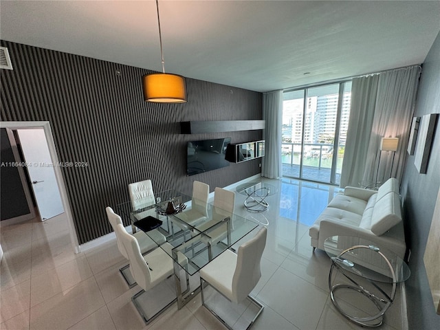 tiled dining space featuring expansive windows