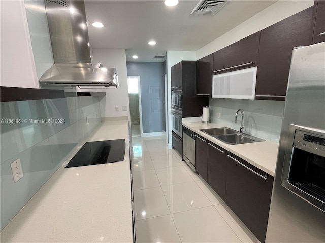 kitchen with tasteful backsplash, light tile patterned floors, stainless steel appliances, island exhaust hood, and sink