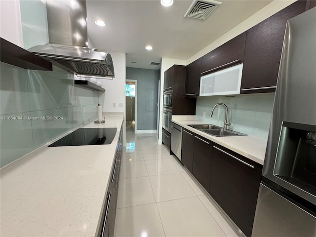 kitchen with island exhaust hood, appliances with stainless steel finishes, light tile patterned flooring, and sink