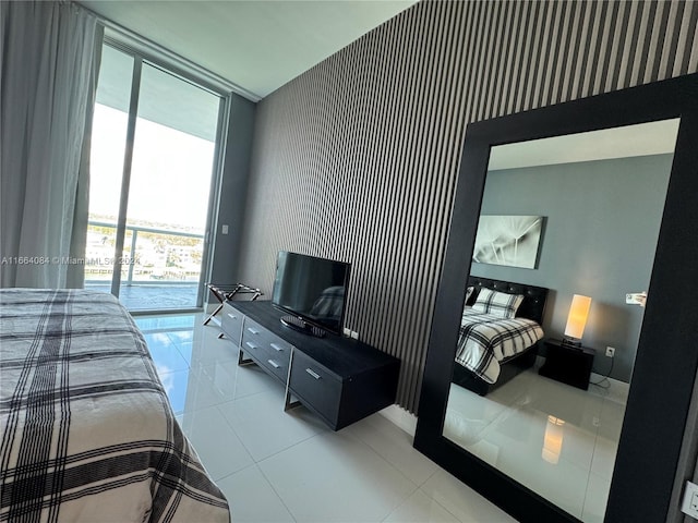 tiled bedroom featuring access to outside and expansive windows