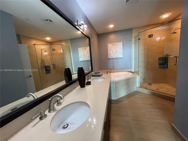 bathroom featuring vanity and separate shower and tub